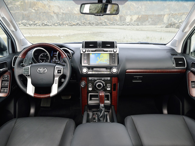 Салон Toyota Land Cruiser Prado салон Салон Toyota Land Cruiser Prado лишен громоздких элементов и слегка уступает оппоненту по качеству отделки